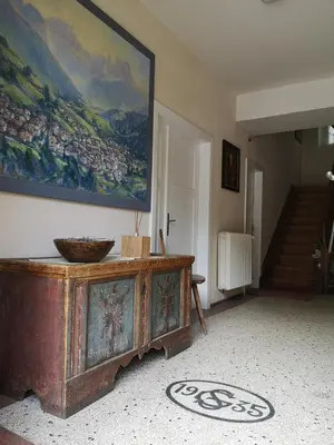 a living room with a large painting on the wall at Molignon - Ortisei - Val Gardena in Ortisei