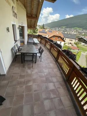a patio with a table and chairs on a balcony at Residence Palmai in Ortisei