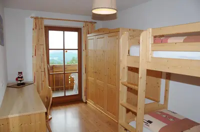 a room with two bunk beds and a window at Zangerlechnhof in Brunico