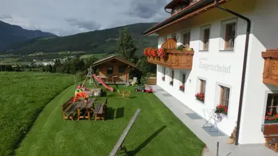 an aerial view of a building with a yard at Zangerlechnhof in Brunico