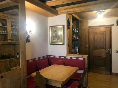 a bedroom with a bed and a tv in a cabin at Cortina Olympic Suite in Cortina dʼAmpezzo
