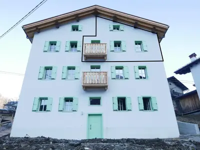 a white building with balconies on it at La Rocia 2 in Rocca Pietore