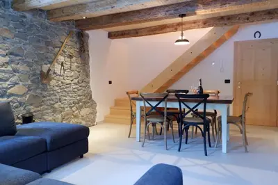 a kitchen and dining room with a table and chairs at La Rocia 2 in Rocca Pietore