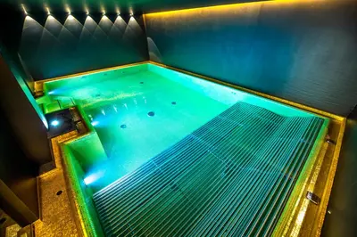 an overhead view of a swimming pool with blue lights at Stella Hotel - My Dolomites Experience in Selva di Val Gardena