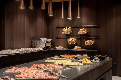 a buffet line with many different types of food at Stella Hotel - My Dolomites Experience in Selva di Val Gardena