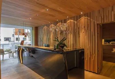 a ping pong table in a room with wooden walls at Stella Hotel - My Dolomites Experience in Selva di Val Gardena