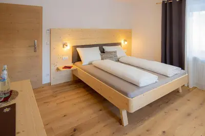 a bedroom with a large bed in a room at B&B Frühlingsheim in Racines