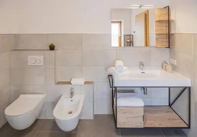a bathroom with a sink and a toilet at B&B Frühlingsheim in Racines