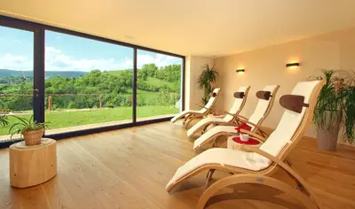 a waiting room with white chairs and a large window at Peternaderhof in Vols am Schlern