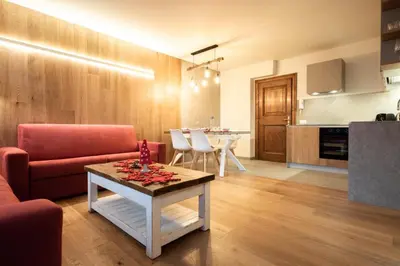 a living room with a couch and a table at Chalet Ruoibes in San Vito di Cadore