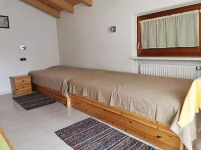 a small bedroom with a bed and a window at Hörtmairhof in Campo Tures
