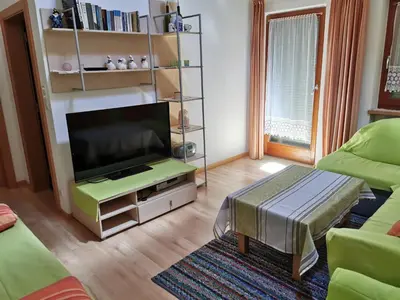 a living room with a flat screen tv and a couch at Hörtmairhof in Campo Tures