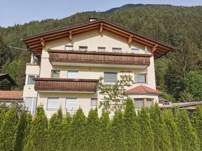 a building with a balcony on top of a hill at Hörtmairhof in Campo Tures