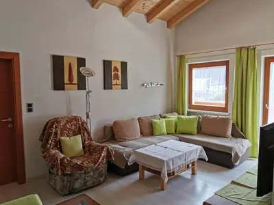a living room with a couch and a chair at Hörtmairhof in Campo Tures