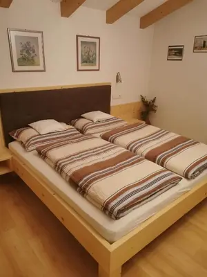 a large bed in a room with two bedsvisor at Hörtmairhof in Campo Tures