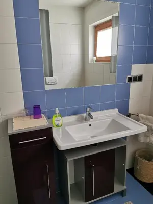a bathroom with a white sink and a mirror at Hörtmairhof in Campo Tures
