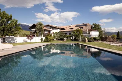 a swimming pool in front of a house at Ebnerhof in Appiano sulla Strada del Vino