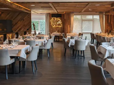 a dining room with white tables and chairs at MONDI Hotel Tscherms in Cermes