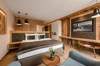 a hotel room with a bed and a tv at MONDI Hotel Tscherms in Cermes