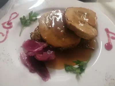 a plate of food with a donut and vegetables at Chalet Hotel Diamant in San Martino in Badia