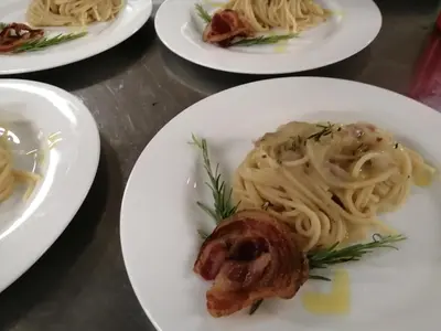 a group of plates of pasta with a piece of meat at Chalet Hotel Diamant in San Martino in Badia