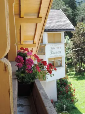 a balcony with flowers on the side of a building at Chalet Hotel Diamant in San Martino in Badia