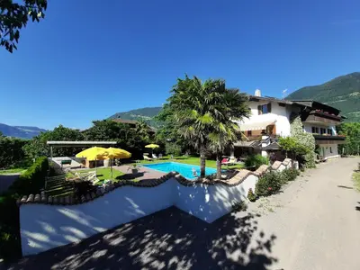 a villa with a swimming pool and a house at Hirschenhof in Laives