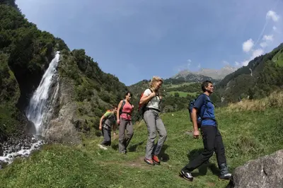 a group of people walking in front of a waterfall at Rabland Haus Texel I in Parcines