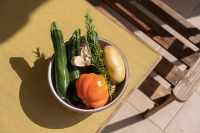 a bowl of vegetables sitting on a table at Rabland Haus Texel I in Parcines