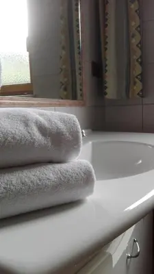 a bathroom with towels on a sink and a mirror at Rabland Haus Texel I in Parcines