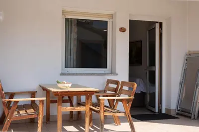 a table and chairs in a room with a window at Ferienwohnung im Haus Texel II in Parcines