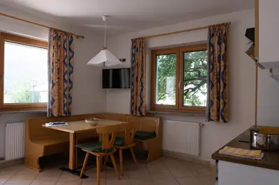a kitchen with a table and chairs and a dining room at Ferienwohnung im Haus Texel II in Parcines