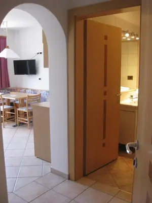 an open door in a kitchen with a table at Ferienwohnung im Haus Texel IV in Parcines