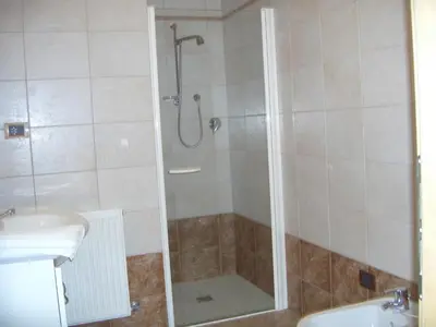 a bathroom with a shower and a sink at Ferienwohnung im Haus Texel IV in Parcines