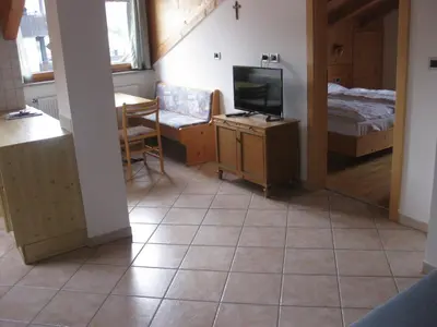 a living room with a television and a bedroom at Ferienwohnung im Haus Texel VI in Parcines