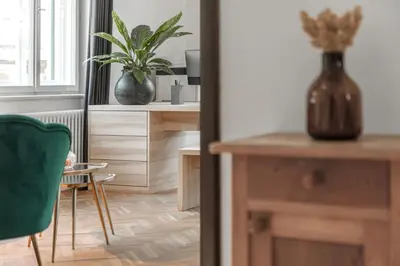 a room with a desk and a green chair at Casa al Sole in Ortisei