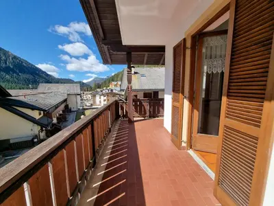 a balcony of a house with a view of the mountains at Solaia in Mazzin