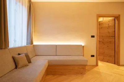 a couch sitting in a room with a window at Ladurner Suites in Merano