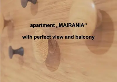 a picture of a persons hand on a wooden table at Ladurner Suites in Merano