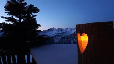 a man standing on a rock wall at B&BeautyFol Dolomites B&B adults only in Predazzo