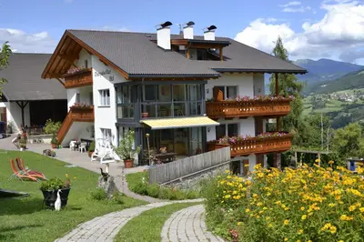 a large house with a balcony and a garden at Oberpalwitterhof in Barbiano