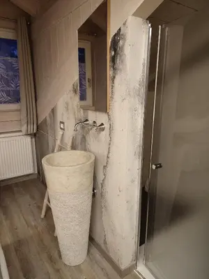 a bathroom with a bucket in the corner of a shower at Sweet Dolomites Sauna & Jacuzzi in Agordo