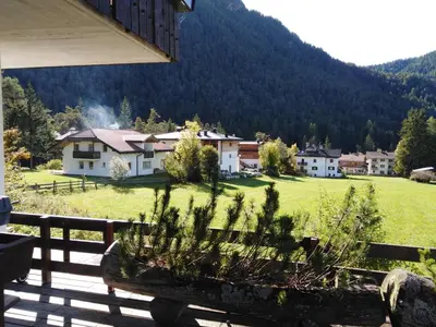 a view from the porch of a house with a field at Ciasa Pascal in San Vigilio