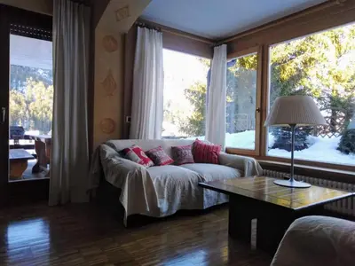 a living room with a couch and a large window at Ciasa Pascal in San Vigilio