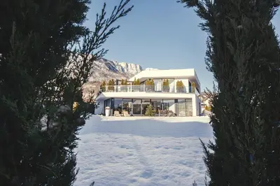 a large house in the snow with a mountain at Villa Aich in Appiano sulla Strada del Vino