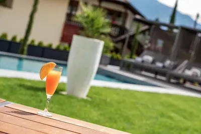 a glass of orange juice sitting on top of a table at Villa Aich in Appiano sulla Strada del Vino