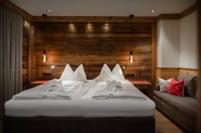 a bedroom with two white beds in front of a window at Apartment Scurcià 41 in Ortisei