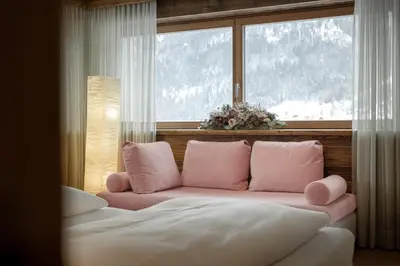 a living room with a pink couch and a window at Apartment Scurcià 41 in Ortisei