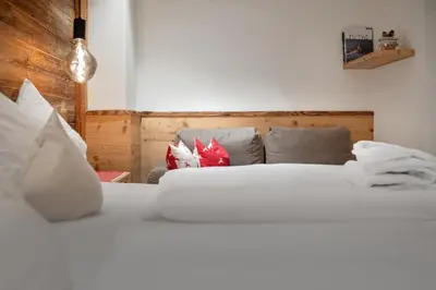 two white beds in a room with at Apartment Scurcià 41 in Ortisei