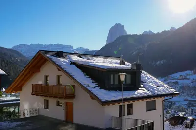 a kitchen with a table and a dining room at Apartment Scurcià 41 in Ortisei